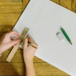 A4 paper size being measured with ruler showing paper dimensions for printing