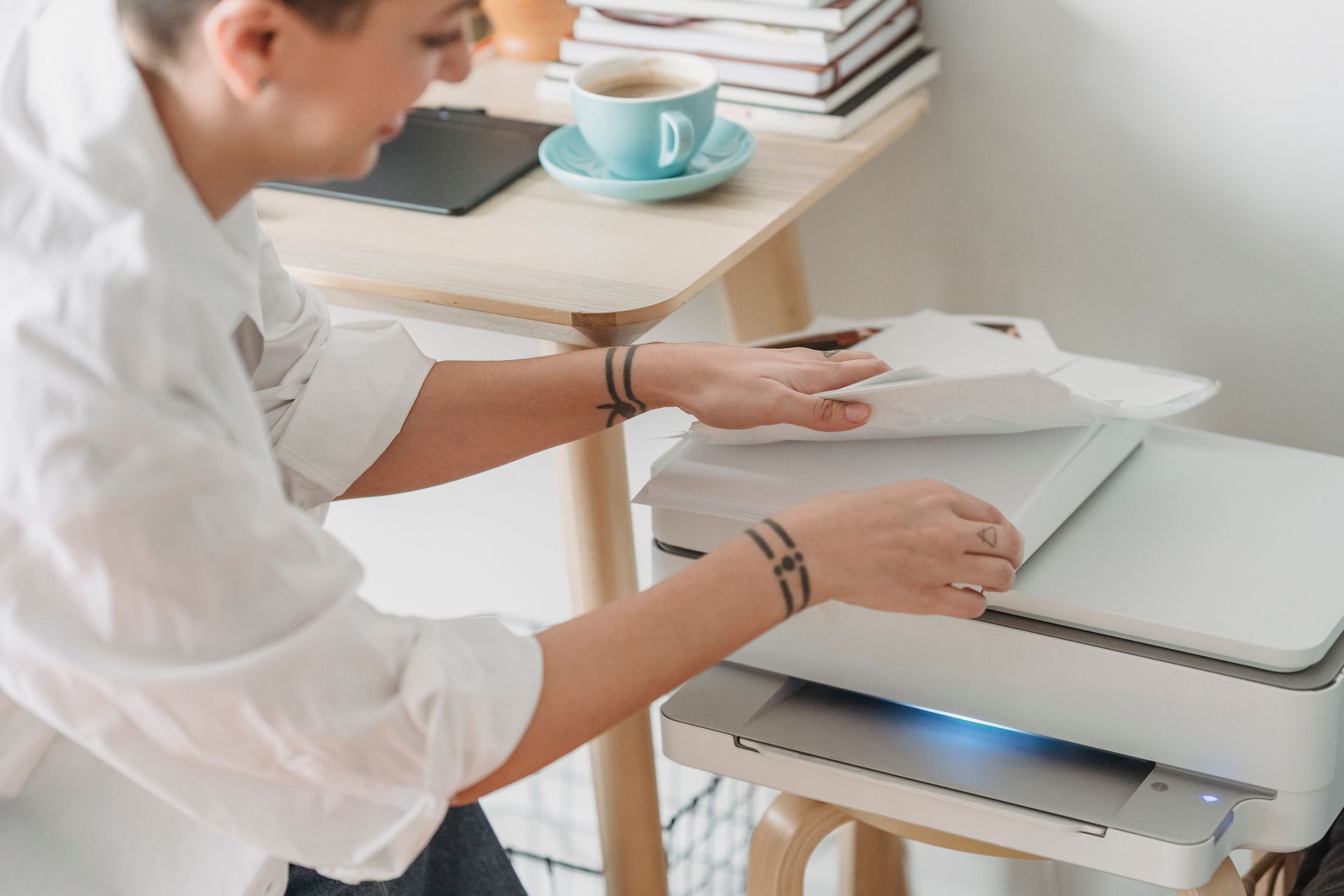 Bulk copy paper being placed into an office printer for daily workplace document printing