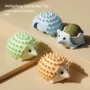 Catnip ball self groomer toys in brown green and blue.